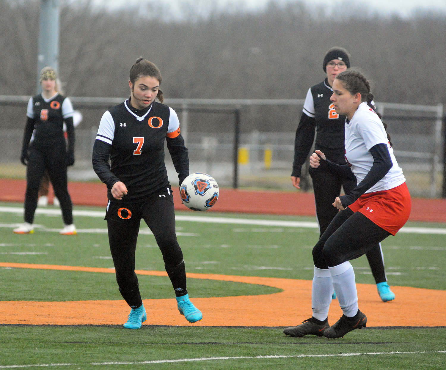 Kylie Kitchen (center) looks to play a ball as it comes down to the ground with Dutchgirl teammates Katie Loyd (far left) and Leah Reed (far right) watching the action unfold from behind. OHS is scheduled to compete this week in the Dixon Girls Soccer Tournament beginning tonight (Wednesday).